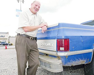 ALL SMILES: Rob Fellman, owner of Boardman Subaru, South Avenue, leans on one of the many “clunkers” he took in on trade during the federal government’s Cash-for-Clunkers program. Under the $3 billion federal program, which ended Monday, new vehicle buyers received from $3,500 to $4,500 cash back for their old gas-guzzling vehicles.