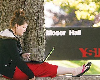 ENROLLMENT UP: Freshman Rachel Clifton of Hubbard, took a moment between classes to check her schedule as Youngstown State University. University officials said first-day enrollment Monday for the fall semester reached 14,425, the highest number in 16 years.