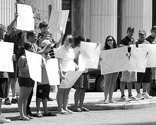 SUPPORTING V&M: A small group of Mahoning County Democrats, most of them high school and college age, stood outside 20 Federal Place in downtown Youngstown in support of a tentative deal reached by Youngstown and Girard officials to help bring a potential $970 million expansion project by V&M Star Steel to the area.