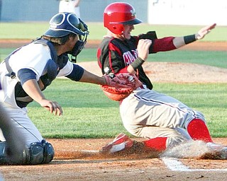 Muckdogs Devin Goodwin is out at the plate during 1st inning Tuesday. Scrappers catcher Chen Chun makes the tag.