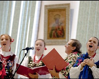 The Vindicator/Geoffrey Hauschild
Cathy Katienich (right) sings alongside (left to right) Agi Khoury, Sara Katienich, and Urszula Gerchak, during the second annual Polish Day Festival at St. Anne Church in Austintown on Sunday afternoon. 
8.30.2009