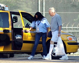 Former Ohio congressman Jim Traficant, left, gets into a cab after being released from federal prison in Rochester, Minn., Wednesday, Sept. 2, 2009. Democrat Traficant is ending a seven-year federal prison stay for accepting bribes and other corruption charges. (AP Photo/Craig Lassig)