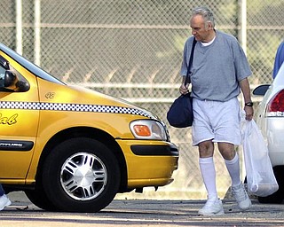 Former Ohio congressman Jim Traficant, left, heads for a cab after being released from federal prison in Rochester, Minn., Wednesday, Sept. 2, 2009. Democrat Traficant is ending a seven-year federal prison stay for accepting bribes and other corruption charges. (AP Photo/Craig Lassig)
