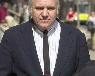 file - In this April 11, 2002 file photo, U.S. Rep. James Traficant Jr. arrives at the federal courthouse in Cleveland to hear the verdict in his bribery and corruption trial. Traficant, the wild-haired ex-congressman nearing release from prison after serving a sentence for corruption, will return to a hometown that has ample evidence of the federal aid he landed, including a highway, second federal courthouse and an arena. (AP Photo/Mark Duncan, File)