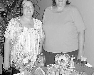 Special to The Vindicator
SHOW TIME: Some of the Chinese auction items that will be available Sept. 20 at the fashion show planned by the ABWA Network Council have been sorted by, from left, Cathy Pokrivnak and Karen Blasko, chairmen of the event.