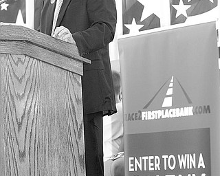 CRUZE CAMPAIGN:  First Place Bank Chief Executive Steve Lewis, at the Canfield Fair, announces the giveaway contest for three Chevrolet Cruze cars. He made the announcement during opening ceremonies at the fair Thursday.