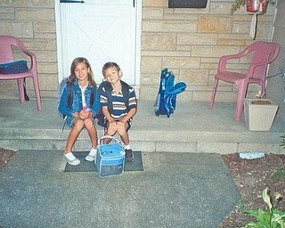 Hope Ramsey, 10, and Bobby Ramsey, 8, are waiting for the bus to take them to Poland Union School last year.