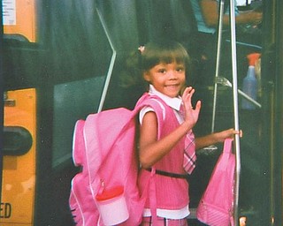 Alexandria Phillips, 5, of Hubbard boards the bus on her day of first grade at Roosevelt Elementary.