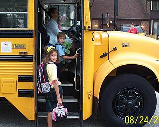 Catching the bus outside their Poland home for their first day of school at Holy Family in Poland are Tyler Hayes, 5, who is in kindergarten, and Katrina Hayes, 10, a fourth grader. They are the children of Darren and Maria Hayes of Poland.