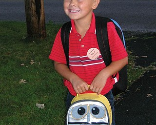 Jacob Spin of Boardman is patiently waiting for the bus to take him on his first day of kindergarten at West Blvd.