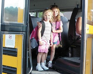 Alivia Miller, 7, a second-grader at Seaborn Elementary in Mineral Ridge, is helping her little sister, Gracie, 5, on her first day of kindergarten.      