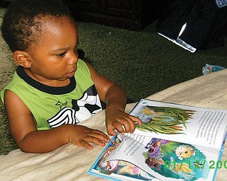 Rachel Parrish of Youngstown says her 15-month-old son, Isaiah Irby, is trying to his best to 'read' like Mommie.