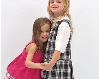 Three-year-old Annika Thompson latches onto big sister Linnea, 5, for the first day of kindergarten at St. Anslem's Church in Chesterland. Parents are John and Kirsten Thompson of Chesterland, and grandma is Marcie Thompson of Mineral Ridge.