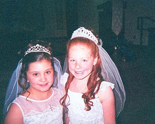 Molly Bury, daughter of Mike and Tina Pallante-Bury of Liberty, is pictured with her friend, Sydney Vukovich, daughter of David and Tammy Vukovich of McDonald, on their first Holy Communion from St. Rose Catholic School in Girard on April 25.