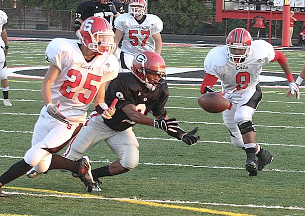 STRUTHERS - GIRARD - (9) Dominic Morgan of Girard comes up with the ball as (25) Dylan Duchek and Norman Cornwell are in on the play for Struthers. - Special to The Vindicator/ Nick Mays
