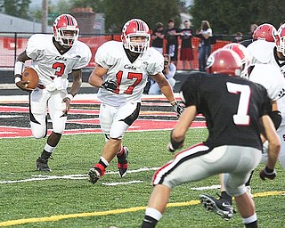 STRUTHERS - GIRARD - (3) Jermayne Brooks follows the blocking of (17) Keith Auman as (7) Gino Mariano of Girard comes up on defense. - Special to The Vindicator/ Nick Mays