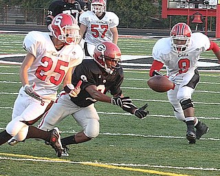 STRUTHERS - GIRARD - (9) Dominic Morgan of Girard comes up with the ball as (25) Dylan Duchek and Norman Cornwell are in on the play for Struthers. - Special to The Vindicator/ Nick Mays