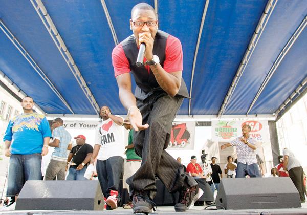 Stef (Steffan Thompson), of Youngstown, performs with his fellow members of FamBoys, including BuddaB (Breandre Allen, with I heart Fam shirt) during the Lucky Penny Family Reunion on Federal Plaza Sunday afternoon.