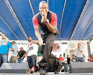 Stef (Steffan Thompson), of Youngstown, performs with his fellow members of FamBoys, including BuddaB (Breandre Allen, with I heart Fam shirt) during the Lucky Penny Family Reunion on Federal Plaza Sunday afternoon.