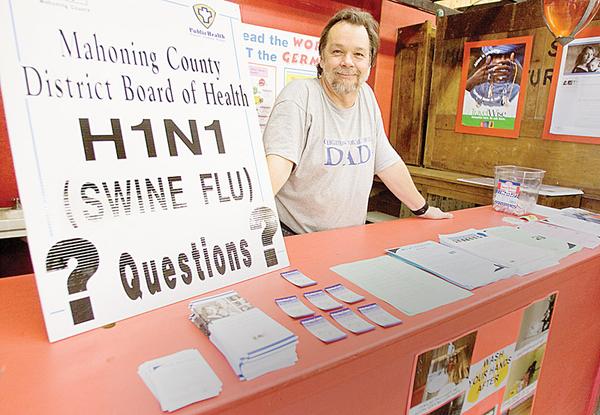 Medical Director of Mahoning County District Board of Health, John Venglarcik M.D., stands at a booth dedicated to dispersing information on the H1N1 Virus at the Canfield Fair on Saturday afternoon.