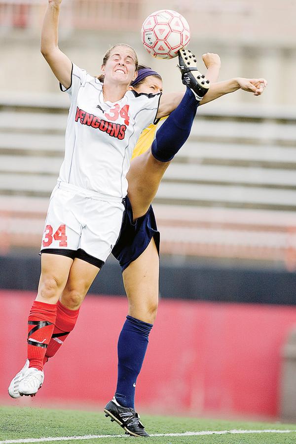 YSU's Kara Cooper goes up for a header with Kent State's Jackie Barath during the second half.