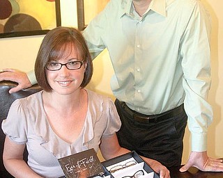 NEW BUSINESS: Jim and Amy Schneider show their new line of eyeglasses, Eyes of Faith. They are starting to market the line to independent eye-care professionals.