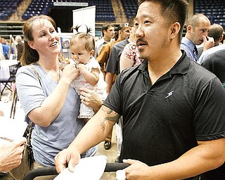 JOB SEARCH: Joel and Penny Johnson of Warren attended Job Expo 2009 at the Covelli Center  with their 4-month-old daughter, Lily. Both 31-year olds lost their jobs when Leedsworld, a maker of promotional supplies, closed its Warren plant in April. Thousands of jobless people packed the downtown arena Wednesday. 