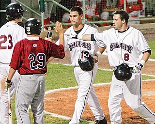 Scrappers Jason Kipnis, right, 8, gets a high five from team mates Casey Frawley, 23, and Argenis Martinez,13, after hitting a 2 run home run the 3rd inning. 