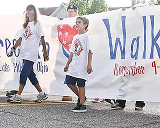 BIG BANNER: Out in front for Lake Milton’s second annual “America Supports You” Freedom Walk was a large “Remember 9-11” banner. Walkers on Thursday showed support for the U.S. military, and remembered victims of the Sept. 11, 2001, terrorist attacks on America.