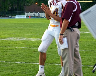 South Range Quarterback Vince Miller confers with Coach Dan Yeagley on a play.