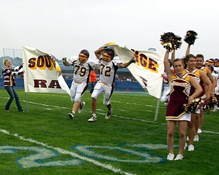 Jeff Baytos and Ron Lodge start the South Range football season by
breaking throught the banner at Massilon Tuslaw.