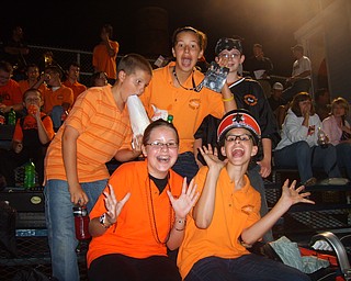 Let the good times roll: Springfield Local Marching Band members enjoy their break after the half time performance. From top left, John Danks, Tiffany Tatar, and Jeremy Blackson. From bottom left, Emma Folkenroth and Angela Buzzacco.