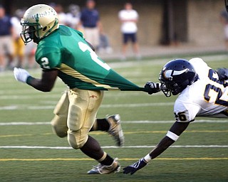 The Vindicator/Robert K. Yosay --  Ursulines #2 Nico Irizarry  breaks a shirt tackle and scores  by Vikings #28 Juwan Haynes during first quarter action at Wheeling Island Stadium 952009