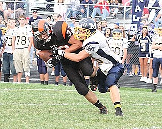 MCDONALD - MINERAL RIDGE - Kyle Skiba is brought down by (10) Justin Rota during their game Friday night. - Special to The Vindicator/Nick Mays