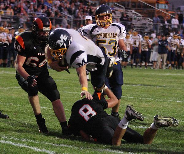MCDONALD - MINERAL RIDGE - (3) Nick Cupan of Mcdonald dives into the end zone over (8) Kyle Butson during their game Friday night. - Special to The Vindicator/Nick Mays