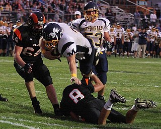 MCDONALD - MINERAL RIDGE - (3) Nick Cupan of Mcdonald dives into the end zone over (8) Kyle Butson during their game Friday night. - Special to The Vindicator/Nick Mays