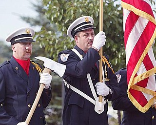 HONOR GUARD: Austintown firefighters John Fritz, left, and Tom Neff stand at attention as part of a special honor guard during a Sept. 11 memorial service in the township. There was a moment of silence as volunteers tolled a bell to symbolize the multiple crashes during the terrorist attacks.