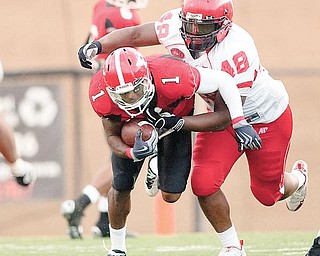 YSU's Kevin Smith (1) is caught by Austin Peay's Nick Clark (48) while driving down field during the fourth quarter on Saturday afternoon at Stambaugh Stadium.