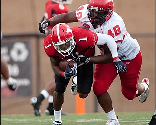 The Vindicator/Geoffrey HauschildYSU's Kevin Smith (1) is caught by Austin Peay's Nick Clark (48) while driving down field during the fourth quarter on Saturday afternoon at Stambaugh Stadium.9.12.2009