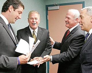 COLLEGE OPENS: From left, U.S. Rep. Tim Ryan of Niles, D-17th; Gov. Ted Strickland; Roy Church, president of Lorain County Community College; and Eric Fingerhut, Ohio chancellor of higher education, share a lighter moment before the official opening ceremony of Eastern Gateway Community College on Monday. The new college will be headquartered in the Medical Education Building of Forum Health’s Northside Medical Center but will offer classes at locations in Mahoning, Trumbull, Columbiana and Jefferson counties.