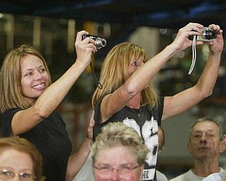 Two workers at GM grab a memory - they were too far back to get names - The Vindicator/Robert K. Yosay ----- Obama speaks to  GM workers and guests at the Lordstown GM Plant  Tuesday  - 9-15-09