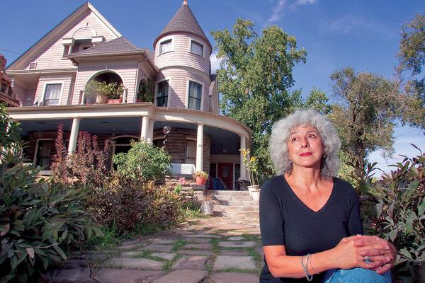 Therese Powell sits outside her recently forclosed home of more than 20 years on Youngstown's North Side. The local activist is the co-chairwoman of Peace Action — Youngstown.