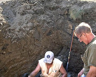 MEN AT WORK: Workers from J.S. Northeast Co., Girard, inspect an area where the new 12-inch waterline will replace the current 6-inch line along North High Street in Cortland. 