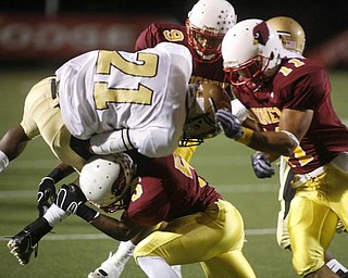 The Vindicator/Robert K. Yosay  -- tied up at the line by three Mooney defenders #21 Harding Deaver Williamson is hit by #5 Braylon Heard  #9 Chuck Grober and #11 Geroge Lyras - during first half action at Stambaugh Stadium - -----9-18-2009