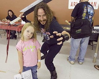 The Vindicator/Lisa-Ann Ishihara--- Ari Lehman, the first Jason Voorhees, poses with Olivia St. John (5) of Rochester, PA during Dark Xmas; an event at the Eastwood Expo Center, Saturday September 19, 2009

