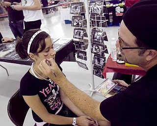 The Vindicator/Lisa-Ann Ishihara --- FX artist Troy Holbrook of Monroe MI makes Kylee Humphrey (12) of Girard look like she's  bruised and cut during Dark Xmas; an event at the Eastwood Expo Center, Saturday September 19, 2009
