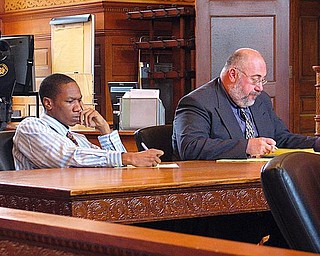 DAY IN COURT: Eugene Cumberbatch, left, listens to testimony and takes notes in Trumbull County Common Pleas Court with his attorney, Joseph Fritz. Cumberbatch, 27, is on trial for the April shooting deaths of Lloyd McCoy Jr., 11, and Marvin Chaney, 26, of Warren. 