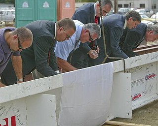 The Vindicator/Robert K. Yosay ----- MAKING HER MARK IN HISTORY - men at work as they all sign the top of THE BEAM  as  University officials and others will sign the final steel beam going into the $34,3 million building.  The beam, carrying U.S. and YSU flags, will then be hoisted into place.  110,000-square-foot facility to  ready for occupancy in fall 2010.  YSU is raising $16 million in private donations to help pay for the construction. 

0232009