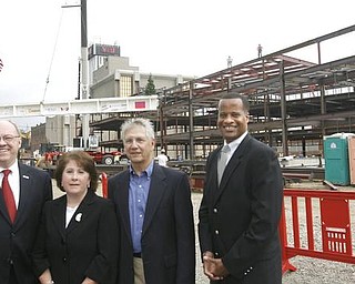 The Vindicator/Robert K. Yosay -----as THE BEAM  is lifted ..  Dr David Sweet- Dean Betty Jo Licata - Warren P Williamson III and Mayor Jay Williams  - as  University officials and others will sign the final steel beam going into the $34,3 million building.  The beam, carrying U.S. and YSU flags, will then be hoisted into place.  110,000-square-foot facility to  ready for occupancy in fall 2010.  YSU is raising $16 million in private donations to help pay for the construction. 

0232009