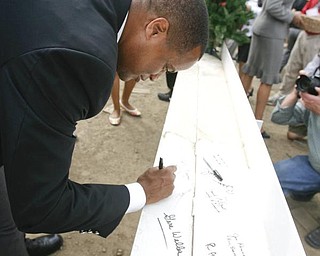 The Vindicator/Robert K. Yosay ----- MAKING HER MARK IN HISTORY - like the proverbial John Hancock... Not to be outdone Mayor Jay Williams - signs THE BEAM  as  University officials and others will sign the final steel beam going into the $34,3 million building.  The beam, carrying U.S. and YSU flags, will then be hoisted into place.  110,000-square-foot facility to  ready for occupancy in fall 2010.  YSU is raising $16 million in private donations to help pay for the construction. 

0232009